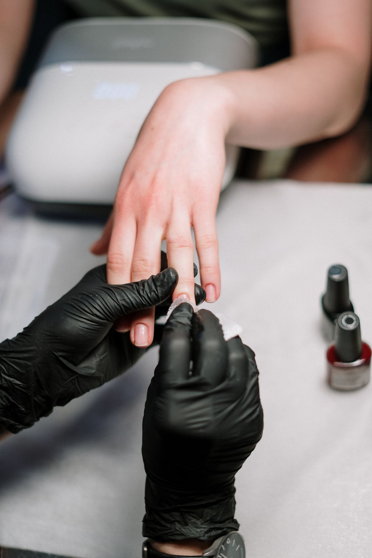 Nail technician working on a gel manicure